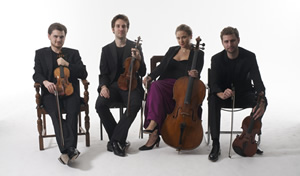 Piatti String Quartet sitting with their instruments
