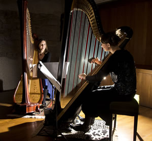 Claire Iselin & Alicia Griffiths seated with their harps