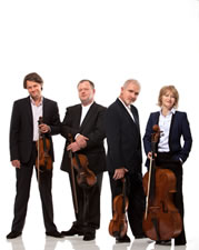 Brodsky Quartet standing with their string instruments