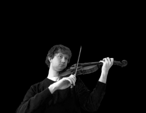 Zack Stephens playing a violin with black background