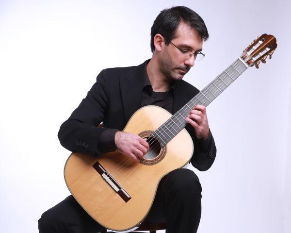 Daniele Piroddi sitting with guitar