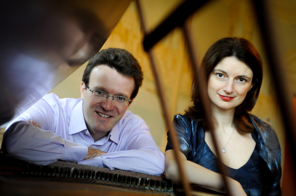 Photo of Emma Abbate and Juliam Perkins looking through top of grand piano