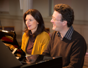 Photo of Emma Abbate and Juliam Perkins at a piano