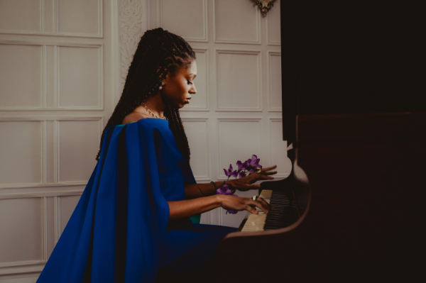 Isata Kanneh-Mason sitting at a piano