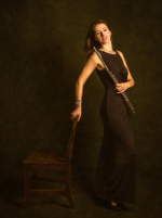 Kathryn Thomas standing and holding her flute.