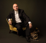 Richard Bayliss sitting with his horn.